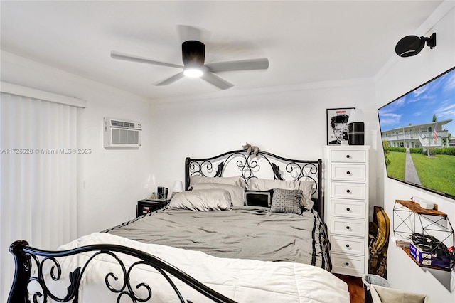 bedroom with ceiling fan, ornamental molding, a wall mounted AC, and hardwood / wood-style floors