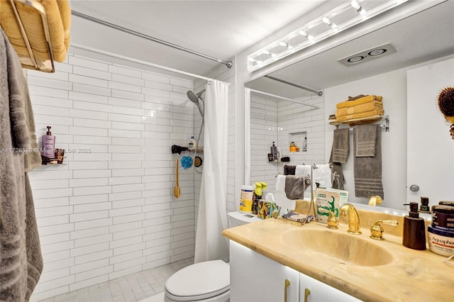 bathroom featuring toilet, vanity, and curtained shower