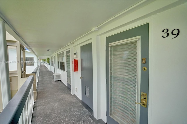 exterior space featuring a wall unit AC and a balcony