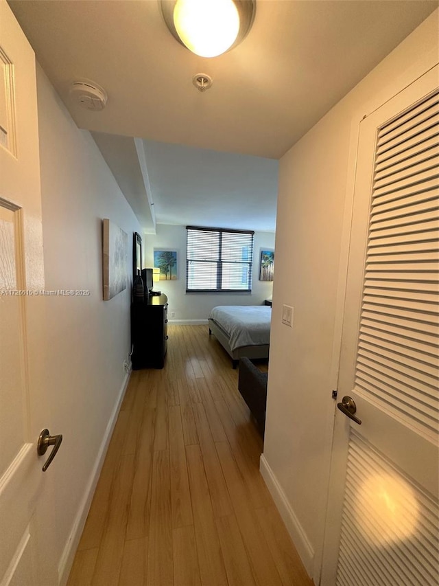 corridor with light hardwood / wood-style floors