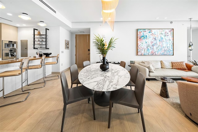 dining area featuring light wood-type flooring