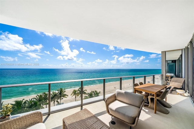 balcony with a beach view and a water view