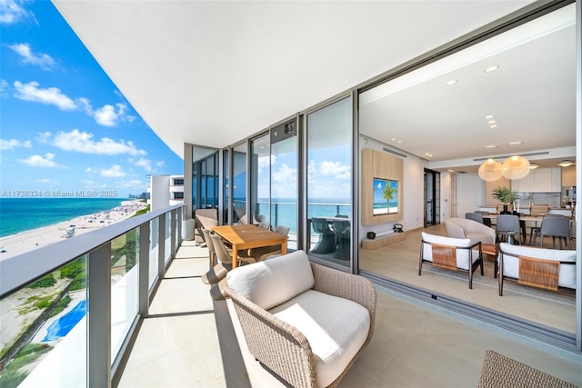 balcony featuring a beach view and a water view