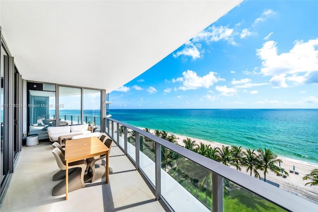 balcony with a beach view and a water view