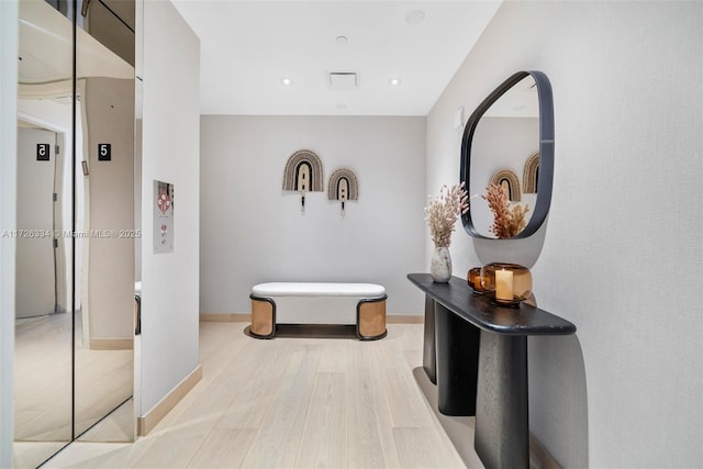 hallway with hardwood / wood-style flooring