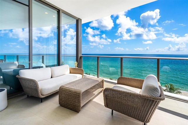 balcony with outdoor lounge area and a water view