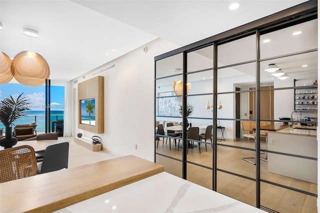 bedroom featuring a wall of windows and a water view