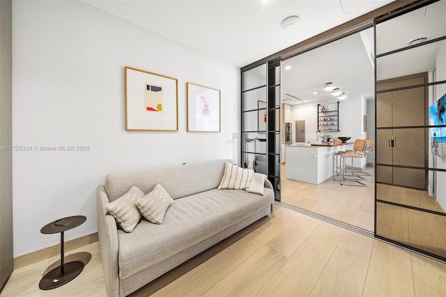 sitting room featuring light hardwood / wood-style flooring