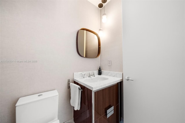 bathroom featuring toilet and vanity