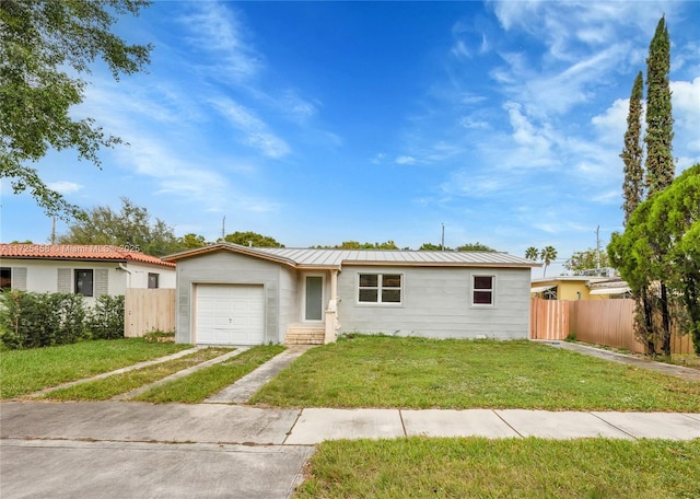 single story home featuring a garage and a front lawn