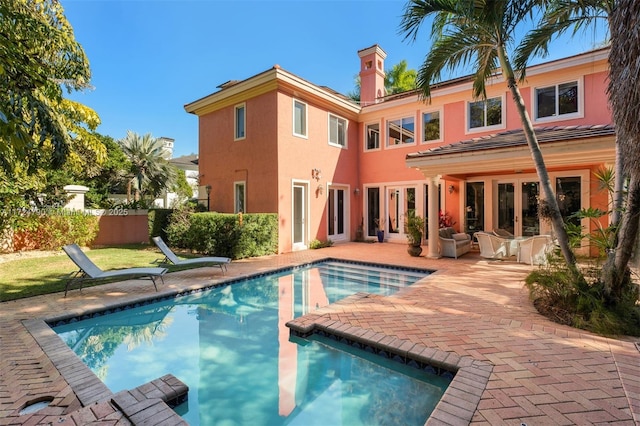 view of swimming pool with a patio area and french doors