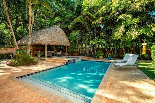 view of swimming pool featuring a gazebo, a patio area, and an in ground hot tub