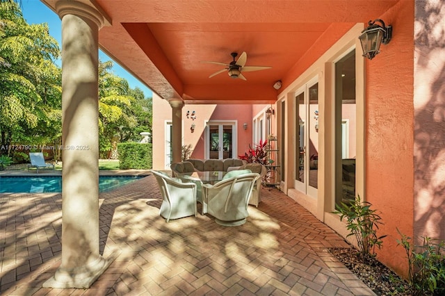 view of patio / terrace featuring ceiling fan and a fenced in pool