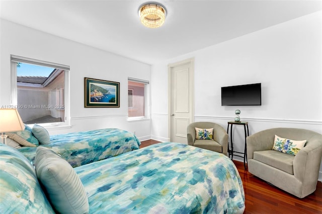 bedroom with dark wood-type flooring