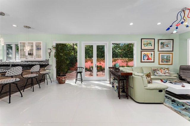 living room with sink and light tile patterned flooring