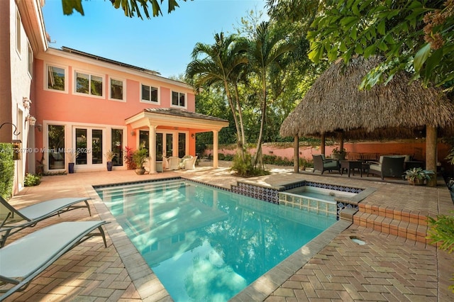 view of swimming pool featuring a gazebo, french doors, a patio area, and an in ground hot tub