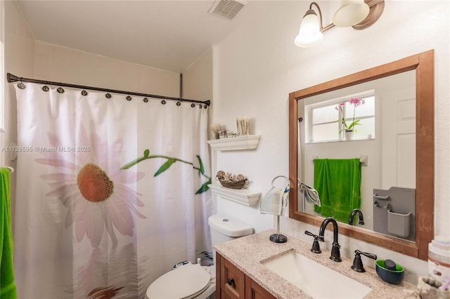 bathroom featuring toilet and vanity