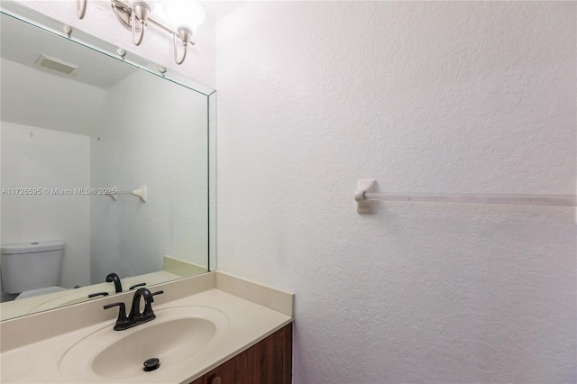 bathroom with toilet and vanity