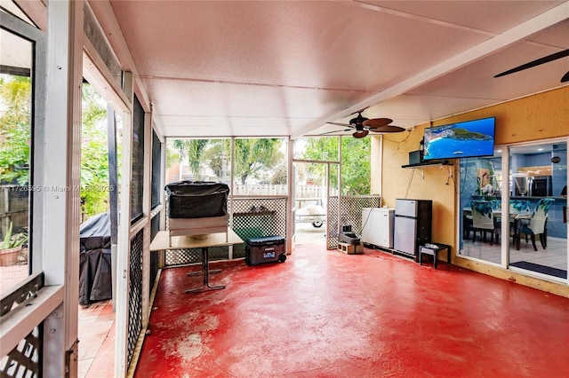 sunroom / solarium featuring ceiling fan