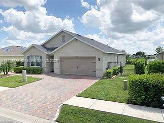 view of front of home with a garage and a front lawn