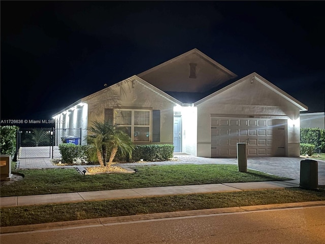 view of front of home featuring a yard and a garage