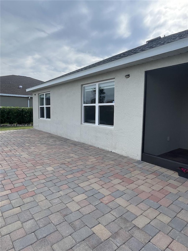exterior space with a patio and stucco siding
