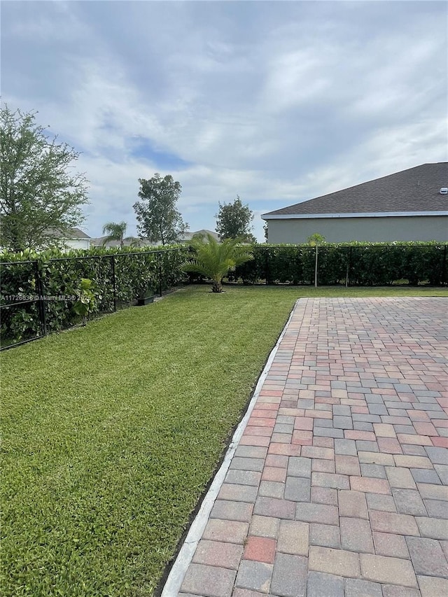 view of yard with a fenced backyard and a patio