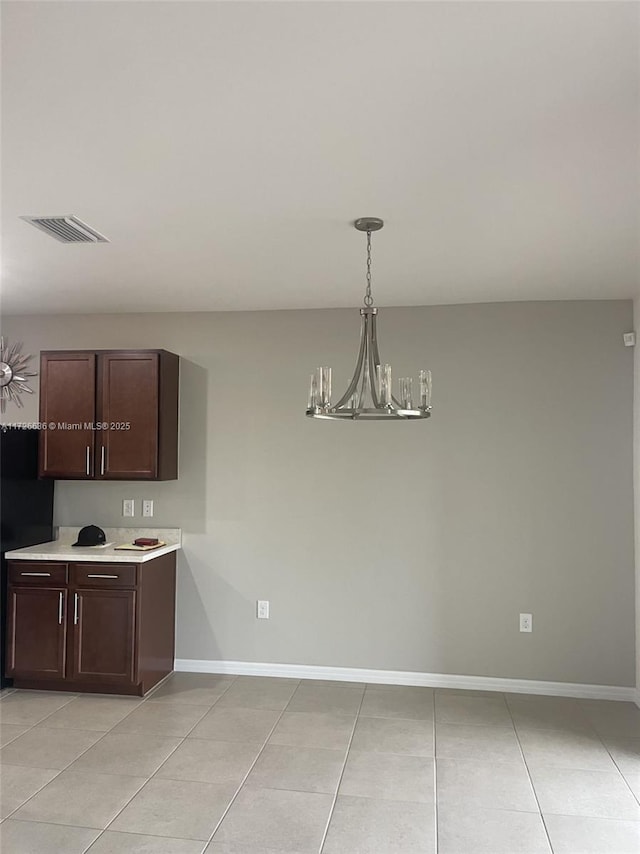 kitchen featuring an inviting chandelier, light countertops, visible vents, and light tile patterned floors