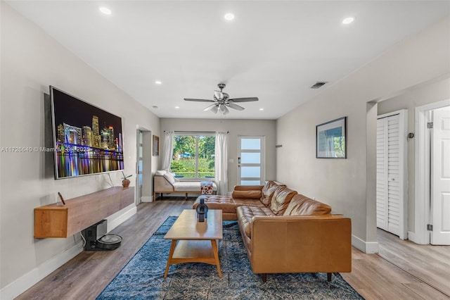 living room with ceiling fan and hardwood / wood-style floors