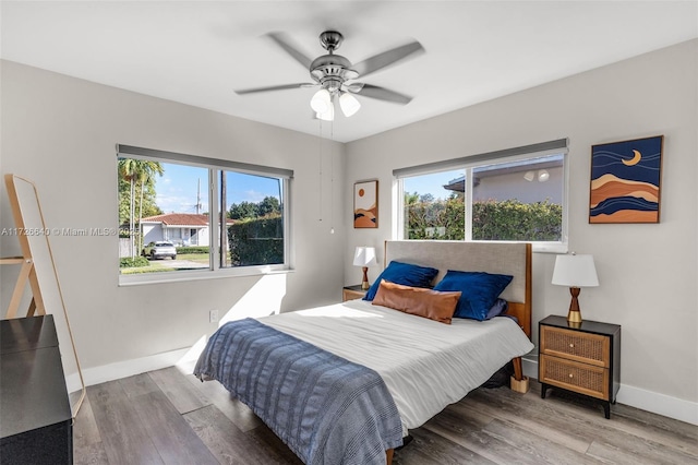 bedroom with hardwood / wood-style floors and ceiling fan