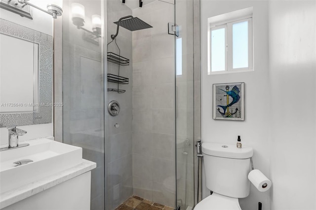 bathroom featuring toilet, a shower with door, and vanity