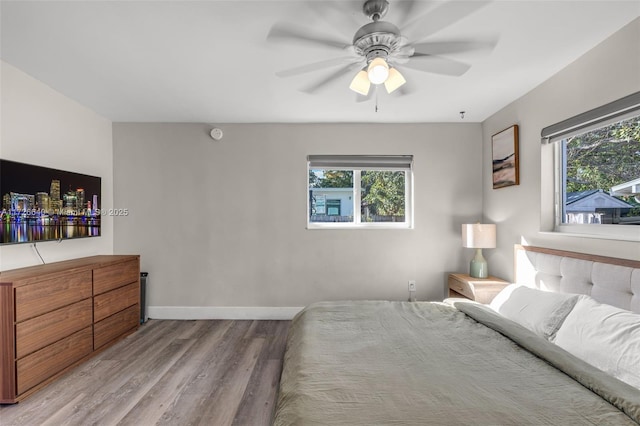 bedroom with ceiling fan and light wood-type flooring