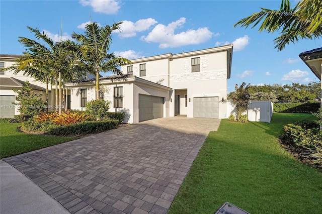 view of front of home featuring a garage and a front lawn