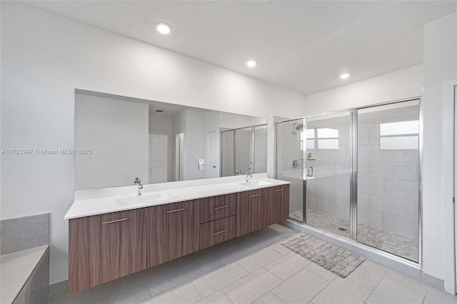 bathroom with tile patterned flooring, vanity, and a shower with shower door