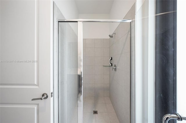 bathroom with a shower with door