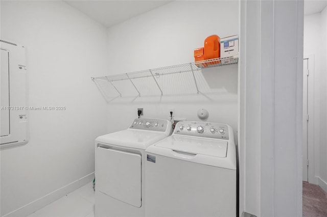 clothes washing area with separate washer and dryer