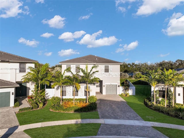 view of front of property with a front lawn and a garage