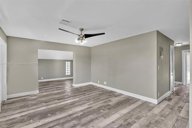 unfurnished room with ceiling fan and light wood-type flooring