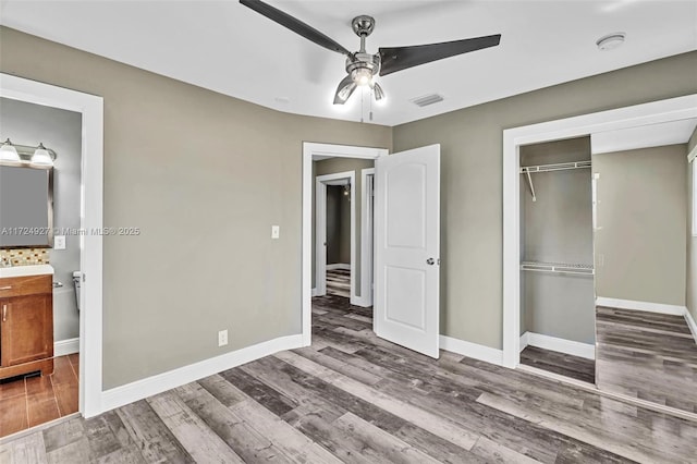 unfurnished bedroom featuring ceiling fan, dark hardwood / wood-style flooring, and a closet