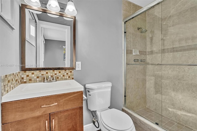 bathroom with an enclosed shower, backsplash, vanity, and toilet