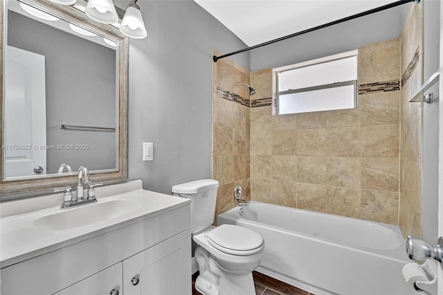 full bathroom with toilet, tiled shower / bath combo, wood-type flooring, and vanity