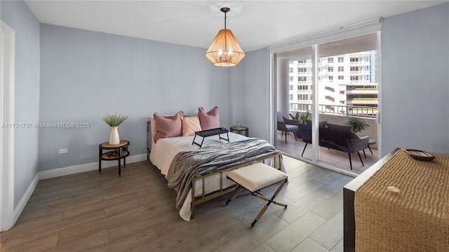 bedroom featuring access to exterior and hardwood / wood-style floors