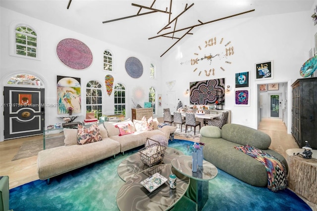 living room featuring high vaulted ceiling and hardwood / wood-style flooring