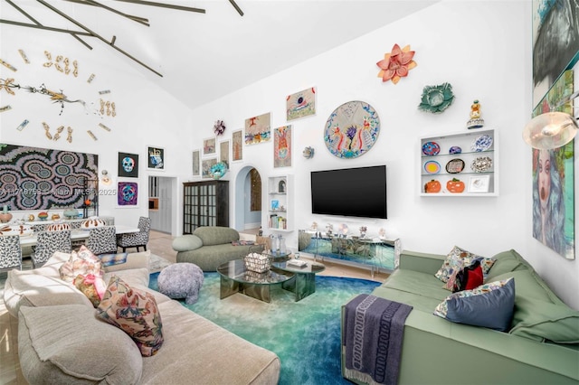 carpeted living room featuring a high ceiling