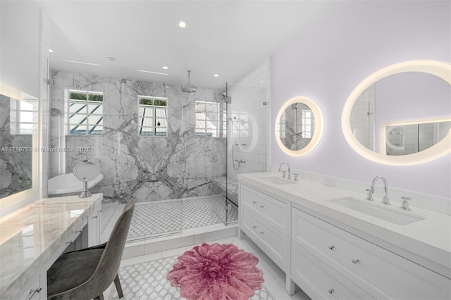 bathroom featuring tile patterned flooring, a tile shower, and vanity