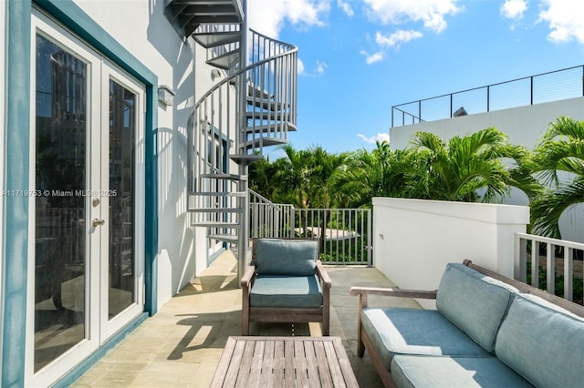 balcony with french doors, outdoor lounge area, and a patio