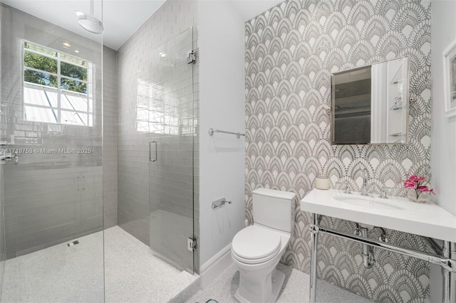 bathroom with sink, an enclosed shower, and toilet