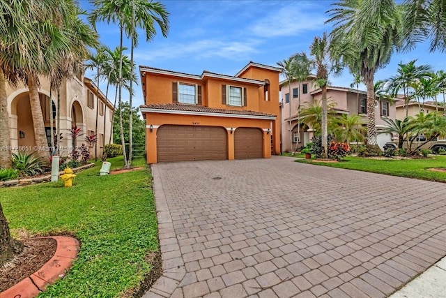 mediterranean / spanish house with a front lawn and a garage