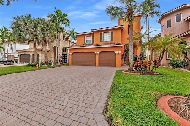 mediterranean / spanish house featuring a front lawn and a garage