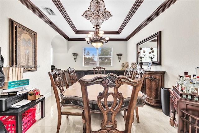 dining space featuring an inviting chandelier and crown molding